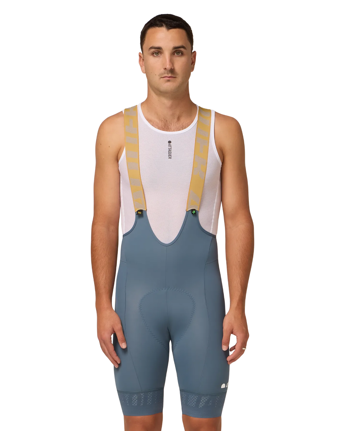 Model in steel-blue Attaquer bib shorts with pale mustard shoulder straps