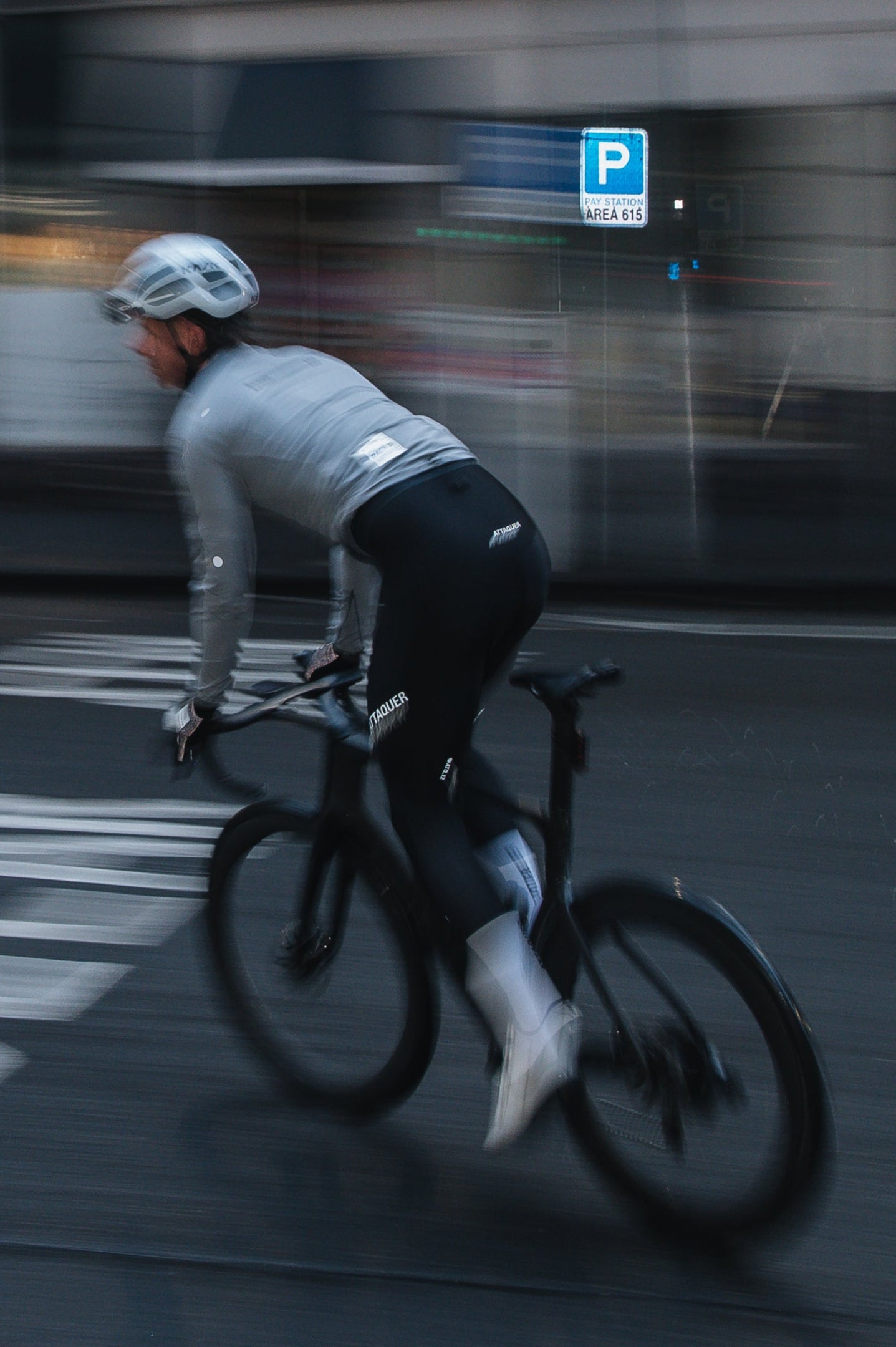 Person cycling on a city street with blurred motion